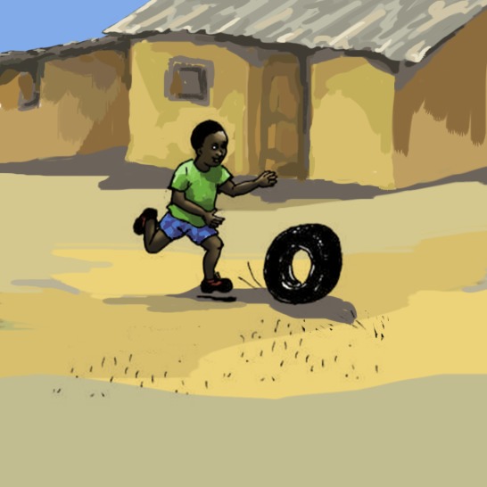 A boy running after a tyre.