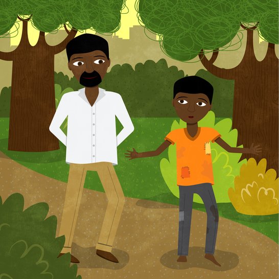 A man and a boy walking in a park.